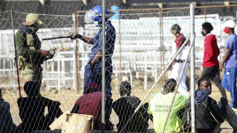 Zimbabwean police and army roundup people at a checkpoint in the countrys capital Harare ahead of planned anti government protests July 30 2020