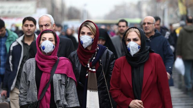 Iranian women wearing protective masks to protect themselves from the coronavirus walk at the Grand Bazaar in Tehran on February 20 2020