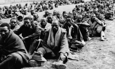 Men detained for allegedly supporting the Mau Mau uprising are seen together in an enclosure in the Thomsons Falls area Kenya on November 30 1952