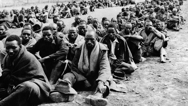 Men detained for allegedly supporting the Mau Mau uprising are seen together in an enclosure in the Thomsons Falls area Kenya on November 30 1952