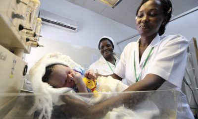 Nurse weighs baby before launch of global strategy for health of women and children by U.N. Secretary-General Ban at Maitama district hospital in Abuja