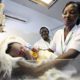 Nurse weighs baby before launch of global strategy for health of women and children by U.N. Secretary-General Ban at Maitama district hospital in Abuja