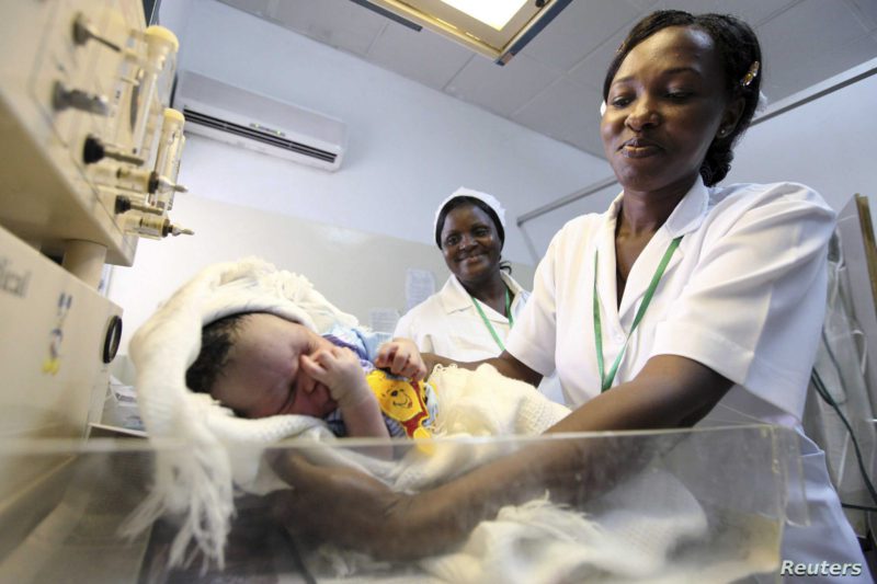 Nurse weighs baby before launch of global strategy for health of women and children by U.N. Secretary-General Ban at Maitama district hospital in Abuja