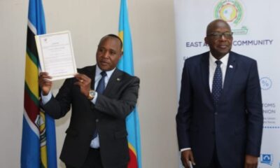Secretary-General Paul Mathuki displays DRC document.