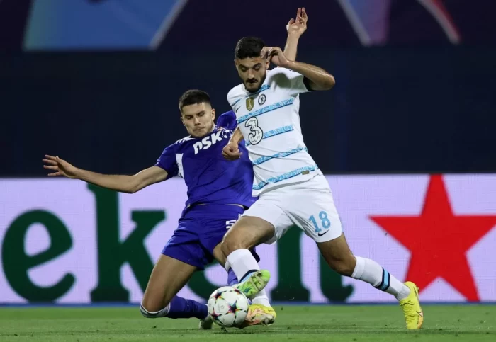 Chelsea's Albania's forward Armando Broja (R) is tackled by Dinamo Zagreb's Croatian defender Dino Peric during the UEFA Champions League Group E football match