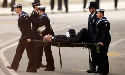 The collapsed police officer carried away on a stretcher