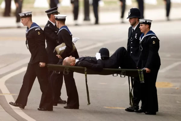 The collapsed police officer carried away on a stretcher
