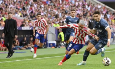 Girona's Spanish midfielder Javier Hernandez (R) vies with Atletico Madrid's French forward Antoine Griezmann during the Spanish League football match between Club Atletico de Madrid and Girona FC at the Wanda Metropolitano stadium in Madrid on October 8, 2022.