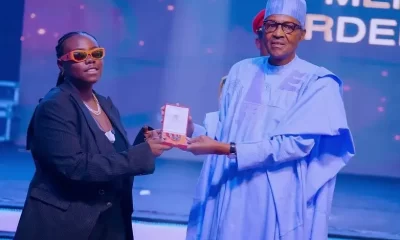 Buhari giving award to Teni