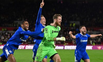 Gillingham's French striker Mikael Mandron (L) and Gillingham's English goalkeeper Jake Turner (C) after the English League Cup third round football match between Brentford and Gillingham at the Brentford Community Stadium in London on November 8, 2022. - Gillingham won the match 6-5 after a penalty shoot-out. (Photo by Glyn KIRK / AFP)