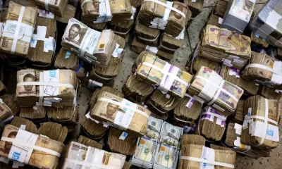 Bundles of naira and dollar