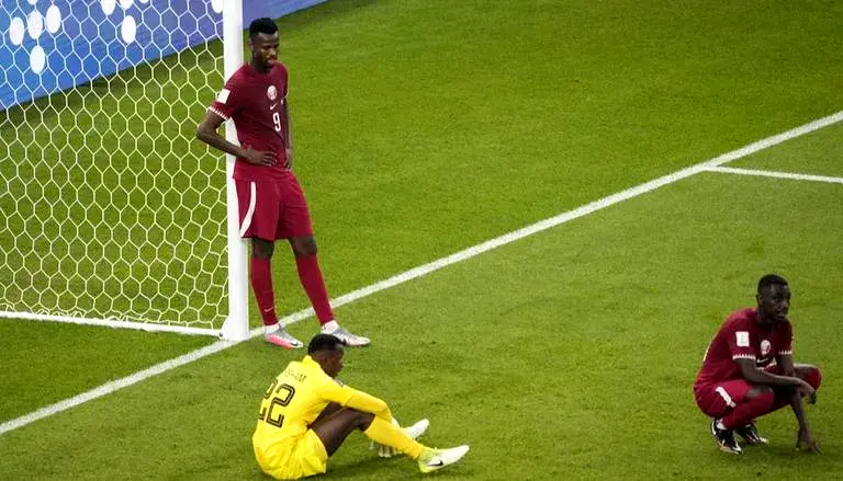 Qatar players react after the final whistle of the Qatar 2022 World Cup Group A football match between Qatar and Senegal at the Al-Thumama Stadium in Doha on November 25, 2022