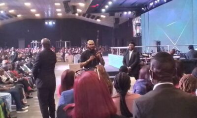 Pastor holds Ak 47 rifle in church