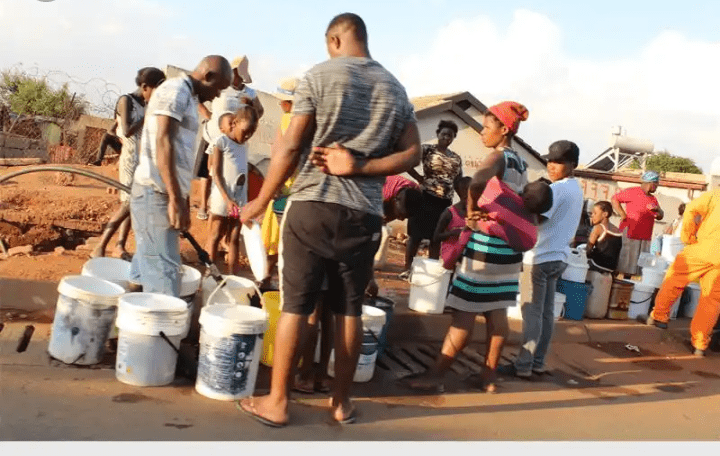People fetching water from a well