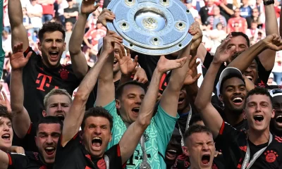 Bayern Munich’s players celebrate with the trophy after the German first division Bundesliga football match between FC Cologne and FC Bayern Munich in Cologne, western Germany on May 27, 2023. (Photo by CHRISTOF STACHE / AFP)