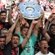 Bayern Munich’s players celebrate with the trophy after the German first division Bundesliga football match between FC Cologne and FC Bayern Munich in Cologne, western Germany on May 27, 2023. (Photo by CHRISTOF STACHE / AFP)