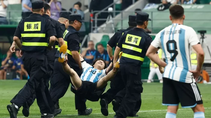 Chinese pitch invader detained after hugging Messi