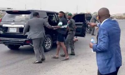 Sanwo-Olu and soldier taking one way