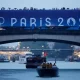 Paris 2024 Olympics – Opening Ceremony – Paris, Paris, France – July 26, 2024. The delegation of Vanuatu is seen passing under a bridge aboard a boat in the floating parade on the river Seine during the opening ceremony. (Photo by Clodagh Kilcoyne / POOL / AFP)