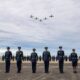This handout photo taken on November 1, 2023 and made available on August 18, 2025 by the New Zealand Defence Force shows T-6C Texan aircraft flying above a graduating parade at the Royal New Zealand Air Force (RNZAF) Base Ohakea, located north-west of the city of Palmerston North in New Zealand. A military court found a New Zealand soldier guilty of attempted espionage for a foreign power on August 18, 2025 -- the first spying conviction in the country's history. The soldier was caught offering to pass military base maps and photographs to an undercover officer posing as an agent for the third country, the court-martial heard. (Photo by Handout / NEW ZEALAND DEFENCE FORCE / AFP) / RESTRICTED TO EDITORIAL USE - MANDATORY CREDIT "AFP PHOTO / NEW ZEALAND DEFENCE FORCE" - NO MARKETING NO ADVERTISING CAMPAIGNS - DISTRIBUTED AS A SERVICE TO CLIENTS / The erroneous mention[s] appearing in the metadata of this photo by Handout has been modified in AFP systems in the following manner: fixes restrictions. Please immediately remove the erroneous mention[s] from all your online services and delete it (them) from your servers. If you have been authorized by AFP to distribute it (them) to third parties, please ensure that the same actions are carried out by them. Failure to promptly comply with these instructions will entail liability on your part for any continued or post notification usage. Therefore we thank you very much for all your attention and prompt action. We are sorry for the inconvenience this notification may cause and remain at your disposal for any further information you may require.