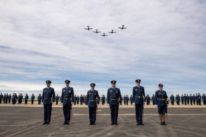 This handout photo taken on November 1, 2023 and made available on August 18, 2025 by the New Zealand Defence Force shows T-6C Texan aircraft flying above a graduating parade at the Royal New Zealand Air Force (RNZAF) Base Ohakea, located north-west of the city of Palmerston North in New Zealand. A military court found a New Zealand soldier guilty of attempted espionage for a foreign power on August 18, 2025 -- the first spying conviction in the country's history. The soldier was caught offering to pass military base maps and photographs to an undercover officer posing as an agent for the third country, the court-martial heard. (Photo by Handout / NEW ZEALAND DEFENCE FORCE / AFP) / RESTRICTED TO EDITORIAL USE - MANDATORY CREDIT "AFP PHOTO / NEW ZEALAND DEFENCE FORCE" - NO MARKETING NO ADVERTISING CAMPAIGNS - DISTRIBUTED AS A SERVICE TO CLIENTS / The erroneous mention[s] appearing in the metadata of this photo by Handout has been modified in AFP systems in the following manner: fixes restrictions. Please immediately remove the erroneous mention[s] from all your online services and delete it (them) from your servers. If you have been authorized by AFP to distribute it (them) to third parties, please ensure that the same actions are carried out by them. Failure to promptly comply with these instructions will entail liability on your part for any continued or post notification usage. Therefore we thank you very much for all your attention and prompt action. We are sorry for the inconvenience this notification may cause and remain at your disposal for any further information you may require.